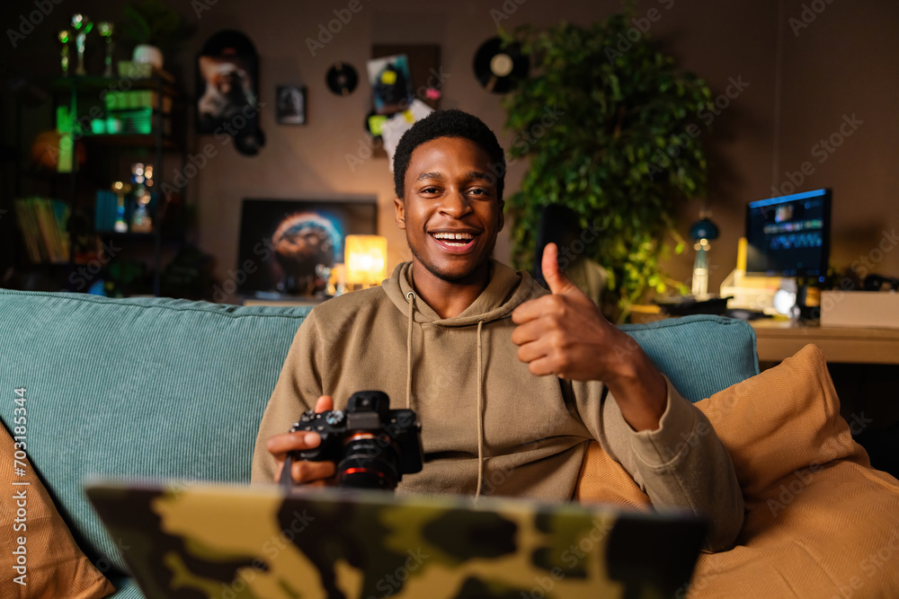Happy delighted African American dark skinned guy enjoying photography