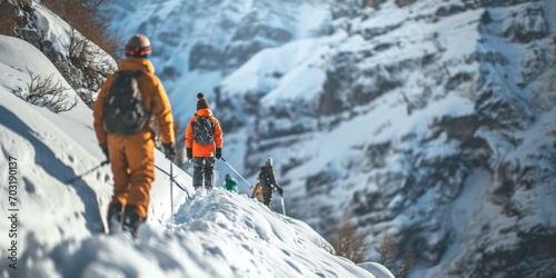 A group of people hiking up the side of a snow covered mountain. Suitable for outdoor adventure and winter activity themes