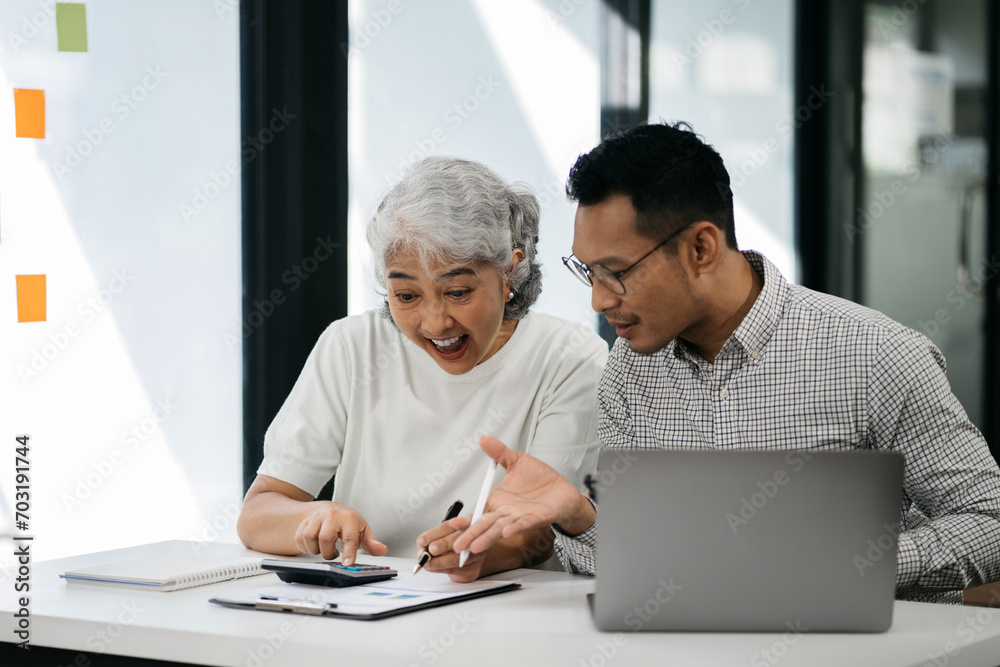 Business team using a calculator to calculate the numbers of statistic business profits growth rate on documents graph data, desk in the office. Business team using a calculator to calculate the numbers of statistic business profits growth rate on documents graph data, desk in the office.