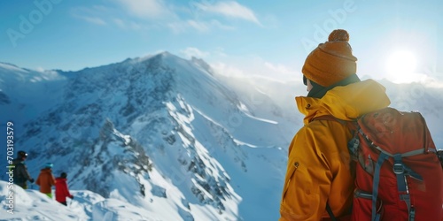 A person with a backpack standing on a snowy mountain. Suitable for outdoor adventure or travel themes