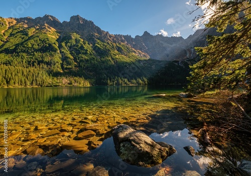 Beautiful, colorful mountain lake with an azure surface and mountain peaks with beautiful sunlight. Morskie Oko - Eye of the Sea - Tatry - Tatra Mountains.Polska Most beautiful places in Poland Polska © Ivan