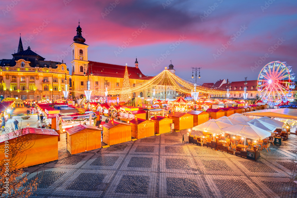 Fototapeta premium Sibiu, Romania. Christmas Market in Large Square, medieval downtown of Transylvania, famous European Xmas Fair.