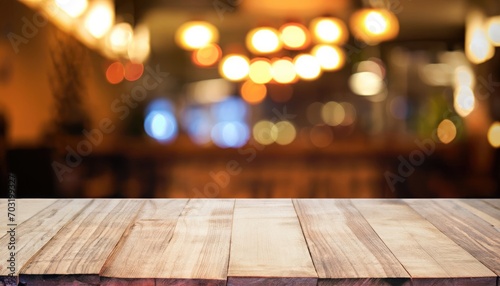 Wooden table in front of abstract blurred background of restaurant lights