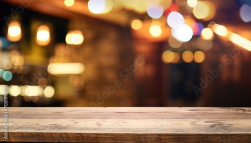 Wooden table in front of abstract blurred background of restaurant lights