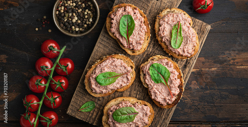 bruschetta with homemade liver pate on rustic wooden background, view from above 