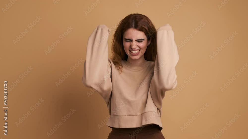 A young caucasian woman shouting in despair A young caucasian woman shouting in despair