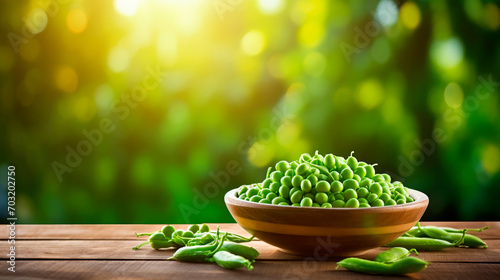 Green peas in a bowl against the backdrop of the garden. Selective focus. photo