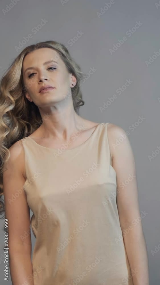 Vertical slow motion video of woman turns his head, waving his long wavy hair. Female hair beauty concept. Vertical slow motion video of woman turns his head, waving his long wavy hair. Female hair beauty concept.