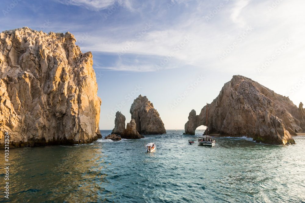 Leisure boats with tourists near famous natural Arch in Baja California, Mexico