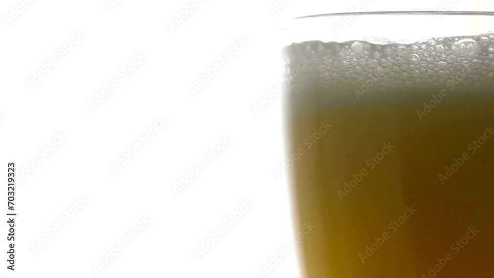 Golden beer is pouring into the glass making bubbles and foam. close-up. Filmed Golden beer is pouring into the glass making bubbles and foam. close-up. Filmed
