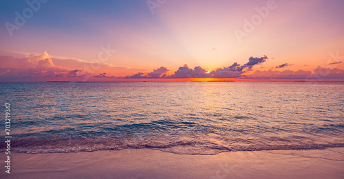 Sea sand sky concept, sunset colors clouds beachfront horizon. Inspire waves beams, meditation nature landscape, beautiful colors, wonderful scenery of tropical beach. Beachside travel summer vacation © icemanphotos
