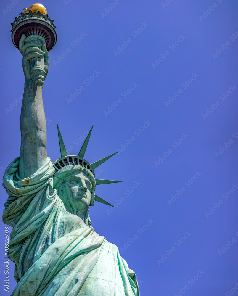 Fototapeta premium The Statue of Liberty holding its torch is the democratic symbol of New York (USA) and the Big Apple, famous in Manhattan and around the world.