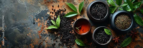 Obraz Herbal tea background. Tea cups with various dried tea leaves and flowers shot from above on rustic wooden table. Assortment of dry tea in ceramic bowls
