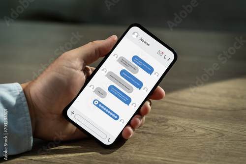 Man chatting on mobile phone chat message online screen app in smartphone photo
