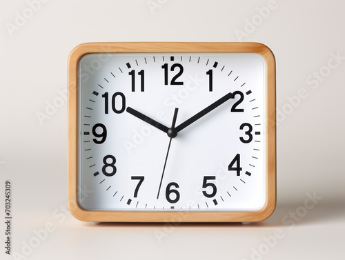 Small square alarm clock, black numbers, set the time for 10.10 o'clock, on white background