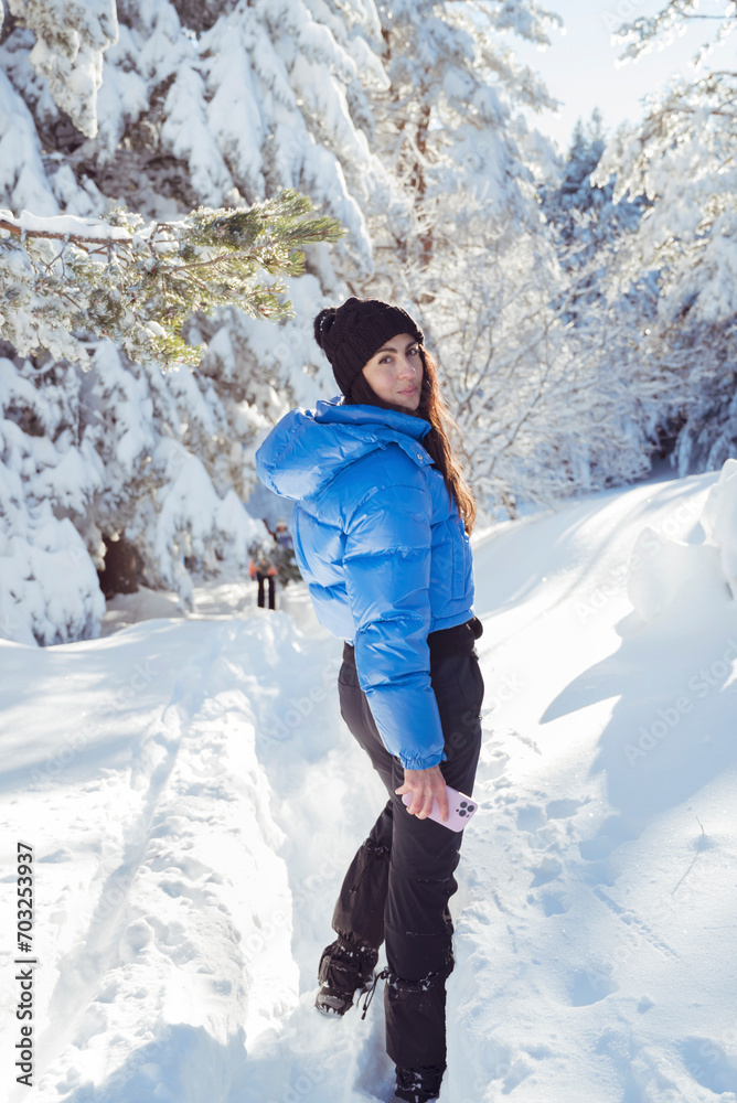 Beautiful woman with warm blue jacket walking in the winter mountain .Vitosha ,Bulgaria 