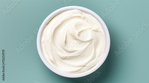 Bowl of tasty sour cream on wooden table