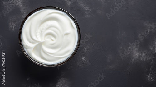 Bowl of tasty sour cream on wooden table