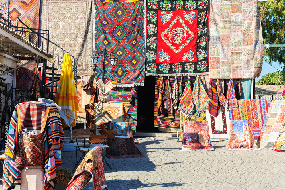 Turkish carpets. Street shop near Didyma Apollo Temple. Travelling and shopping, traditional handmade souvenirs. Didim (Aydin), Turkey (Turkiye) - obrazy, fototapety, plakaty 