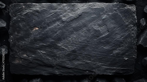 Slate over old wooden background photo