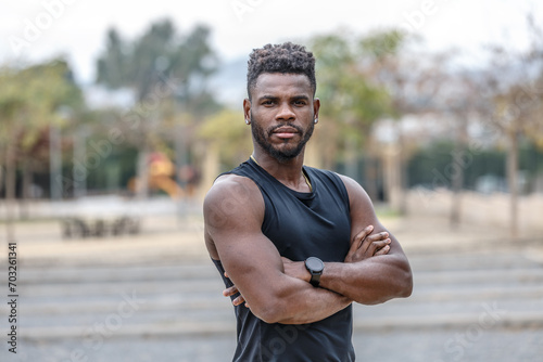 Confident African American sportsman with arms crossed