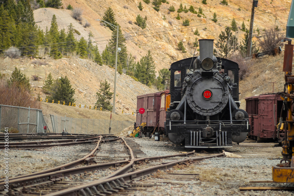 Obraz premium Front view of steam locomotive of Georgetown loop railroad in Colorado, USA. Engine is parked in a depot, looking from the low profile.