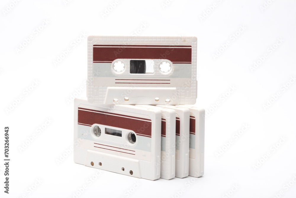 Fototapeta premium Stack of retro 80s audio cassettes on white background