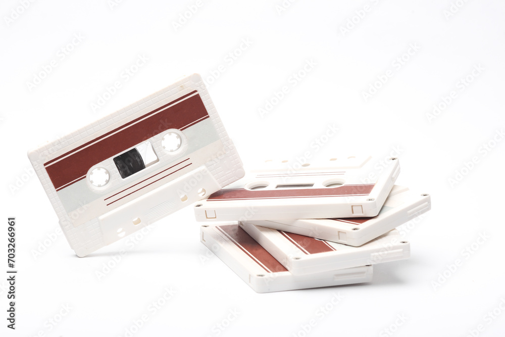 Stack of retro 80s audio cassettes on white background