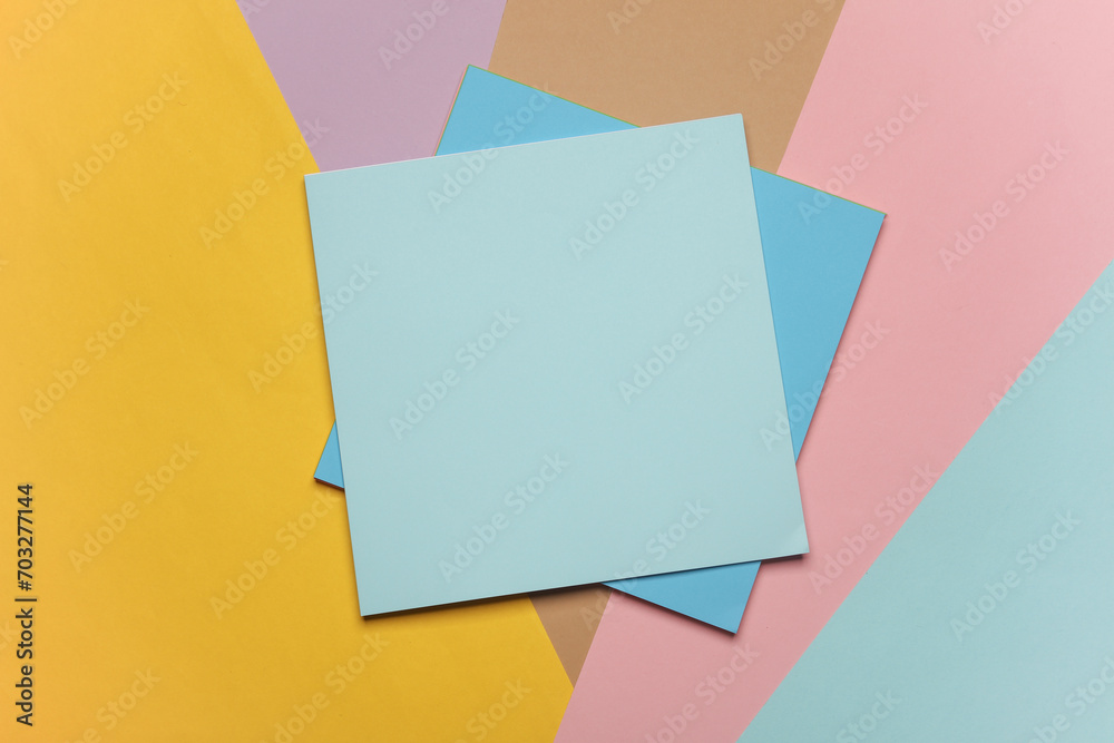 Square sheets of paper for origami creativity on a colored background Square sheets of paper for origami creativity on a colored background