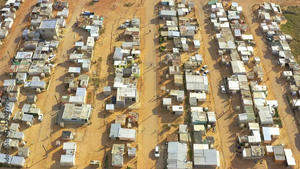 Drone, rooftop of houses in village and infrastructure, informal settlement or township landscape. Community, poverty and road in township with buildings, location in South Africa with aerial view Drone, rooftop of houses in village and infrastructure, informal settlement or township landscape. Community, poverty and road in township with buildings, location in South Africa with aerial view