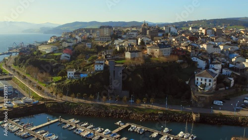 Aerial shot, drone point of view, panorama Ribadeo city and harbor with moored nautical vessels during sunny winter day. Province of Lugo in Galicia. Europe, Northern Spain. Travel and tourism concept photo