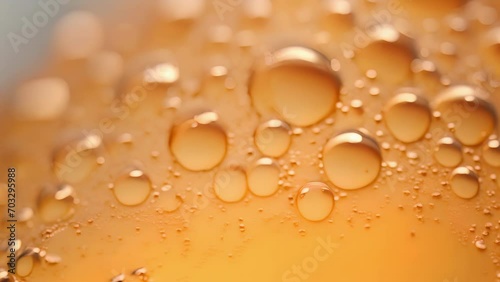 A mesmerizing macro shot of carbon dioxide bubbles rising to the top of a freshly poured beer, a result of the fermentation process. photo