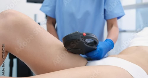 Body care and laser epilation of legs. Cosmetologist and hair removal on the leg of young woman. Hairless smooth and soft skin concept photo