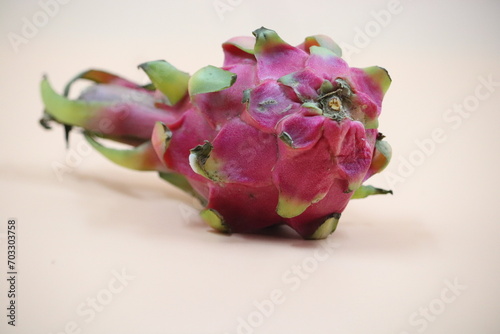 Closeup of a dragon fruit on a beige surface