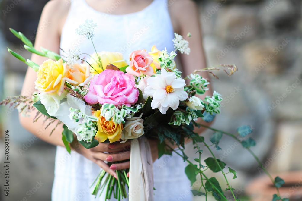 Young bride in white wedding dress holding beautiful bouquet Young bride in white wedding dress holding beautiful bouquet