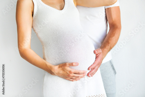 Wallpaper Mural Young man and pretty pregnant woman hugging together Torontodigital.ca