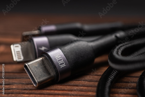 digital computer or smartphone cables. Usb type c, mini-usb, lightning connector. on wooden background photo