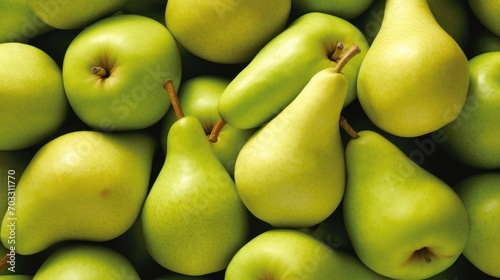  a pile of green pears and pears with one pear cut in half and one pear in the middle. photo