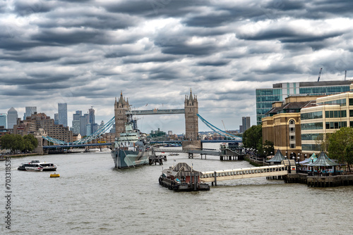 River Thames With Tower Bridge And Warship Belfast In Front Of London Skyline With Modern Skyscrapers In The United Kingdom