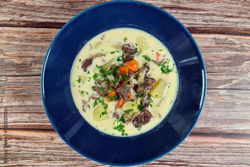 Creamy reindeer soup on blue plate. Top view image. Creamy reindeer soup on blue plate. Top view image.