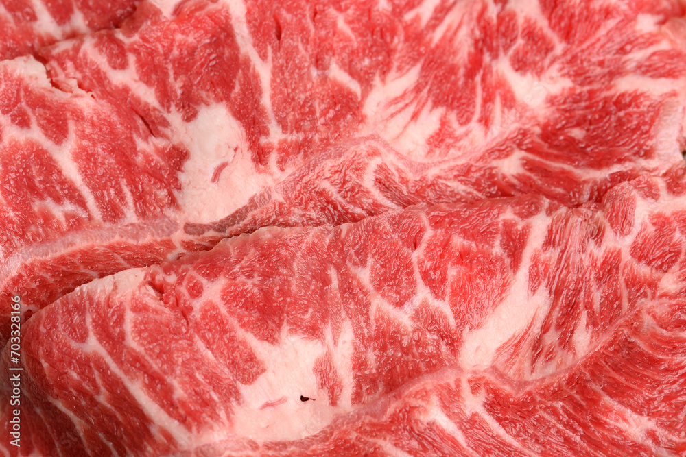 Close-up beef raw red steak on wooden board background.Meat texture. Close-up beef raw red steak on wooden board background.Meat texture.