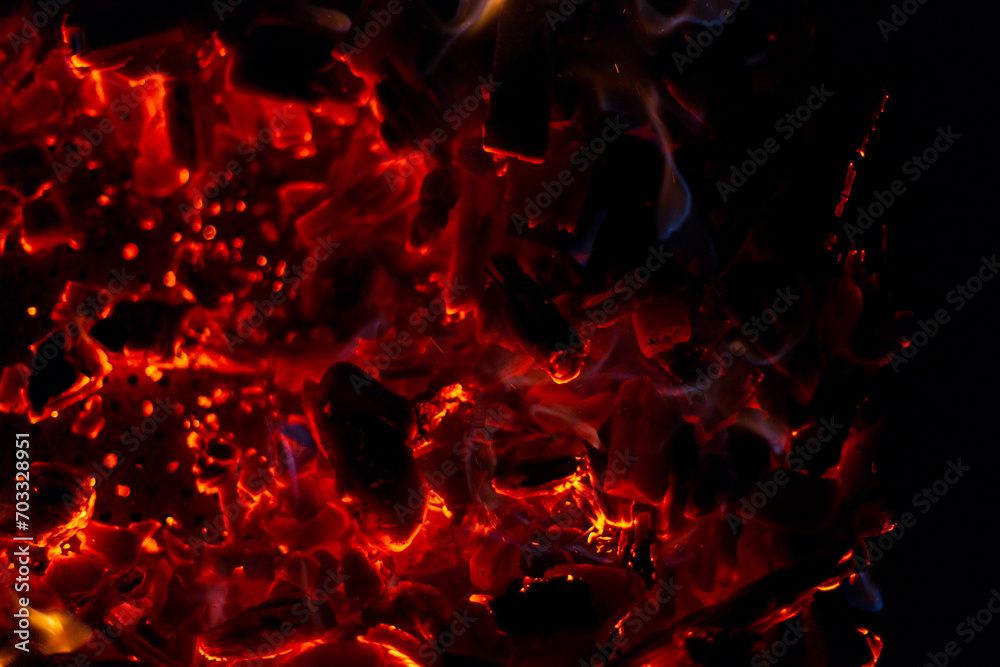 Hot burning coals with sparks on a black background Hot burning coals with sparks on a black background
