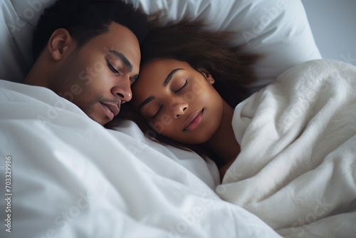 Good quality productive sleep is a concept. Generated by AI. African couple in love sleeps lying in a warm cozy bed hug each other, dreams and recovers strength and energy. White bed linen.