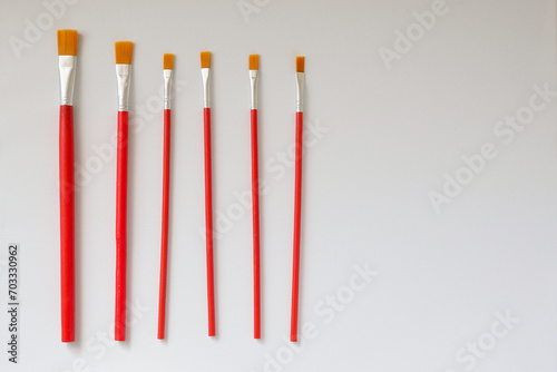 Set of paintbrushes on a white canvas background
