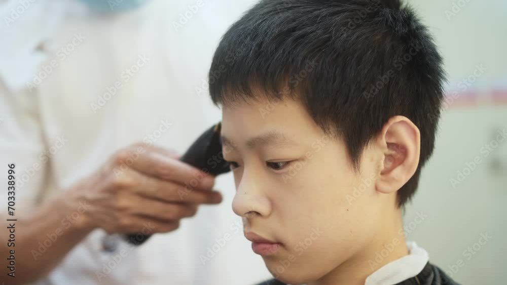 boy haircutting in barber shop boy haircutting in barber shop