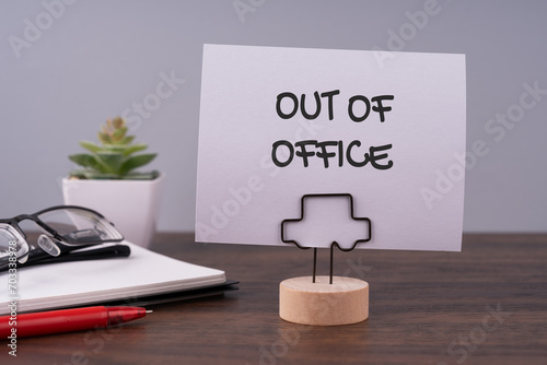 Out of office text on a paper note