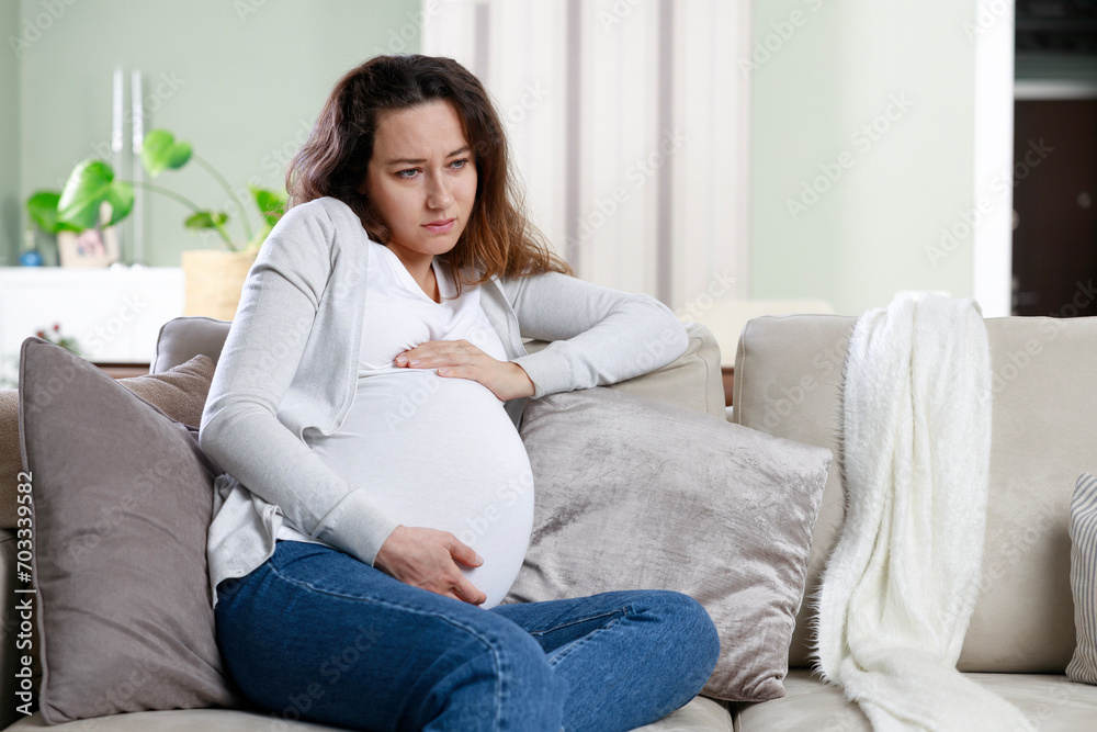 Young woman suffering from nausea and headache during pregnancy Young woman suffering from nausea and headache during pregnancy