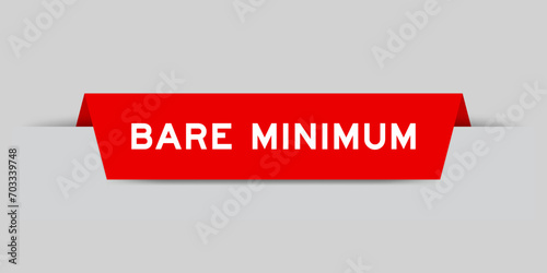 Red color inserted label with word bare minimum on gray background