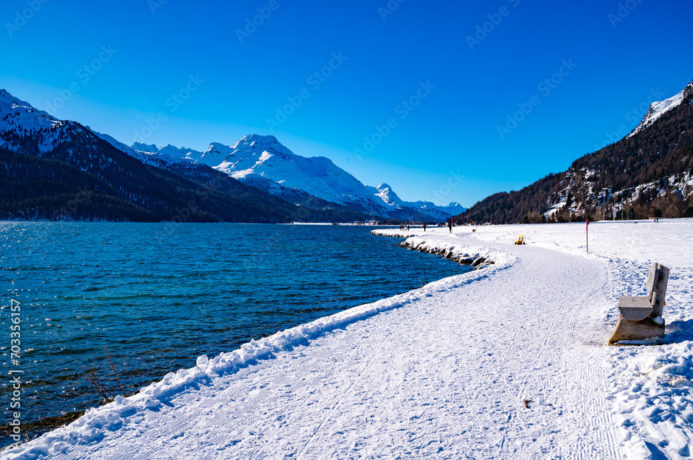 The village and lake of Silvaplana, in Engadine, Grisons, Switzerland, in winter, with snow.
