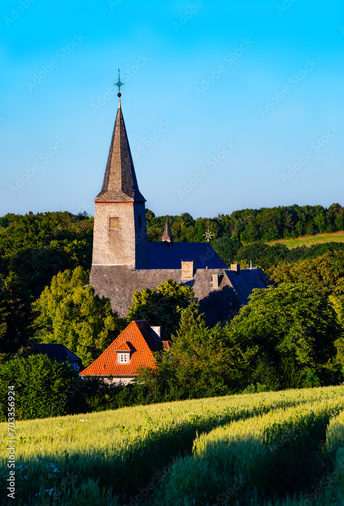 “Kloster Oelinghausen“ is a historic monastery near Arnsberg, Germany. Attraction and monument with old religious tradition and farm in rural landscape of Sauerland scenery on a sunny summer day.